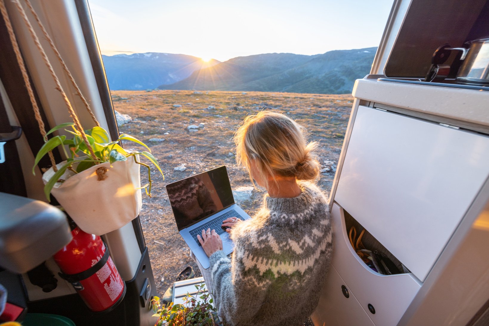 Woman working remotely, van life concept